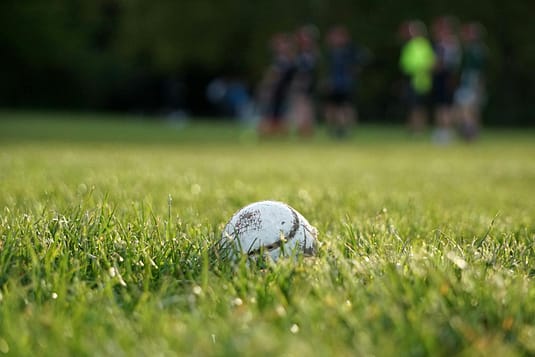 White Soccer Ball on Green Grass Field